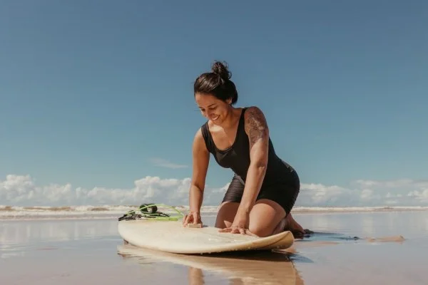 girl surfer training beach